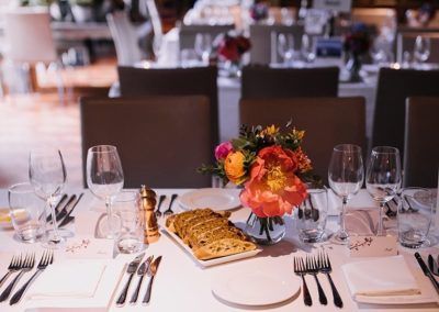 Suesey Street- Events Set-up In Dining Room with Flowers, Glasses and Fresh-Baked Bread